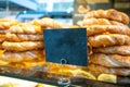 Traditional bagel Turkish simit sesame bread ring, Greek koulouri, empty price board. Copy space