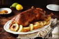 Traditional baked duck with apples and lemon on a dark wooden table Royalty Free Stock Photo