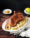 Traditional baked duck with apples and lemon on a dark wooden table Royalty Free Stock Photo