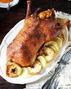 Traditional baked duck with apples and lemon on a dark wooden table Royalty Free Stock Photo