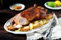 Traditional baked duck with apples and lemon on a dark wooden table Royalty Free Stock Photo