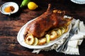 Traditional baked duck with apples and lemon on a dark wooden table Royalty Free Stock Photo