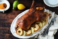 Traditional baked duck with apples and lemon on a dark wooden table Royalty Free Stock Photo