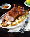 Traditional baked duck with apples and lemon on a dark wooden table Royalty Free Stock Photo