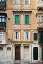 Traditional balconies, doors and windows in a residential block of apartments in Valletta, Malta Royalty Free Stock Photo