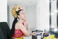 Traditional balinese dancer applying makeup Royalty Free Stock Photo