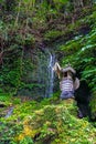 Balinese house of spirits with sacred waterfall wall on background Royalty Free Stock Photo