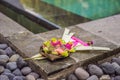 Traditional balinese offerings to gods in Bali with flowers and aromatic sticks Royalty Free Stock Photo