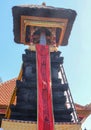 Traditional Balinese religion and architecture in Hindu temple Tanah Lot, Bali, Indonesia. Bale kulkul is a stone tower with a Royalty Free Stock Photo