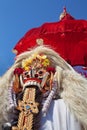 Traditional Balinese spirit Rangda under red umbrella