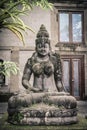 Traditional balinese stone sculpture of a woman in lotus position