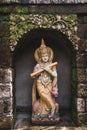 Traditional balinese style hindu statue as decoration in hotel garden.