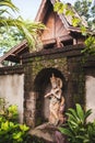 Traditional balinese style hindu statue as decoration in hotel garden.