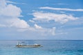 Traditional Balinese wooden fishing boat in the sea against the blue sky. Beaches of Bali. Rest in a heavenly place. Royalty Free Stock Photo