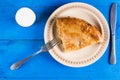 Traditional balkan burek meat pie flat lay above blue wooden background