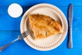 Traditional balkan burek meat pie flat lay above blue wooden background