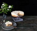Traditional Banoffee Pie banana dessert and white bouquet on a dark background. Copy space