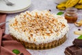 Traditional Banoffee pie with fresh bananas, whipped cream, chocolate, coffee and toffee. No baking dessert.