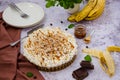 Traditional Banoffee pie with fresh bananas, whipped cream, chocolate, coffee and toffee. No baking dessert.