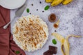 Traditional Banoffee pie with fresh bananas, whipped cream, chocolate, coffee and toffee. No baking dessert.