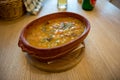 Traditional barley porridge boiled with beans served in a clay bowl.