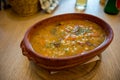 Traditional barley porridge boiled with beans served in a clay bowl.