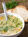 Traditional barley soup with meat in a white bowl