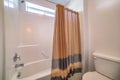 Traditional bathroom with brown shower curtain with black stripes