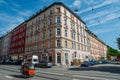 Traditional Bavarian architecture in the centre of Munich on a sunny day. Woman cycles in a push cart with her kids