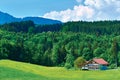 Traditional bavarian family farm house next to a forest in Bavaria region, Germany