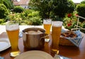 traditional Bavarian meal: white sausages, salty pretzels, sweet mustard, German beer and basket of prezels on Bavarian napkin Royalty Free Stock Photo