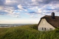 A traditional beach house behind the sand dunes near the Baltic Sea Royalty Free Stock Photo