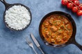 Traditional Beef Madras Indian spicy lamb food with rice and tomatoes in cast iron pan Royalty Free Stock Photo