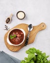 Traditional beetroot soup Borscht on cutting board on light background with sour cream, pepper and fresh herb Royalty Free Stock Photo