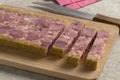 Traditional Belgian brawn, head cheese in slices on a cutting board