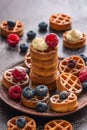 Traditional Belgian waffles with berries. Waffles with cream, raspberries and blueberries. Selective focus