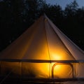 Traditional bell tent glows at night