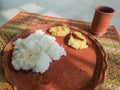 Traditional bengali home cooked thali or platter served on plate made of clay. boiled rice, lentil and potato. authentic indian Royalty Free Stock Photo