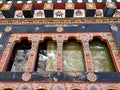 Traditional Bhutanese windows with intricate patterns on a decorated wall, bhutan Royalty Free Stock Photo