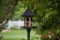 traditional birdhouse with matching feeder on classic black pole