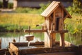 traditional birdhouse with water and seed feeders on a wooden post