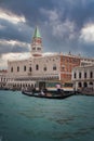 Traditional Venetian Gondola with Occupants and Church in Background on Water in Venice Royalty Free Stock Photo