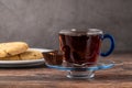 Traditional black turkish tea with lemon and cookies on wooden background