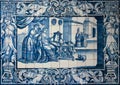 Traditional blue tiles or azulejos decorated with a domestic scene. Lisbon. Portugal Royalty Free Stock Photo