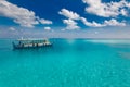 Traditional boat in Maldives, Dhoni in blue turquoise sea under blue sky with white fluffy clouds. Exotic sea bay Royalty Free Stock Photo