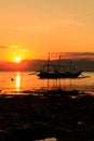 Traditional boat in silhouette against a setting sun Royalty Free Stock Photo