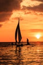 Traditional boat in silhouette against a setting sun Royalty Free Stock Photo