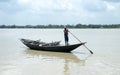 Traditional boatman ferry people Majhi rowing boat called Nauka on river Ganges Ganga. Rural Indian travel tourism and water Royalty Free Stock Photo