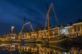 Traditional boats in the harbor from Dokkum in Netherlands in christmas time at twilight