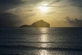 Traditional boats are laying on wave surface of the sea with a long big mountain, beautiful sunrise or sunset and cloud , filtered Royalty Free Stock Photo